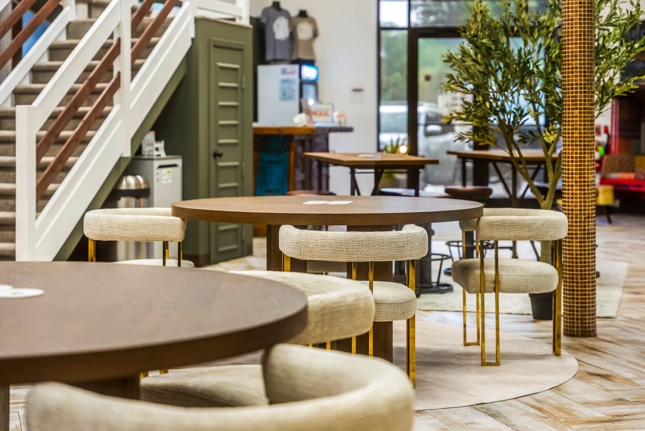 Cafe seating with round wooden tables at WorkLodge
