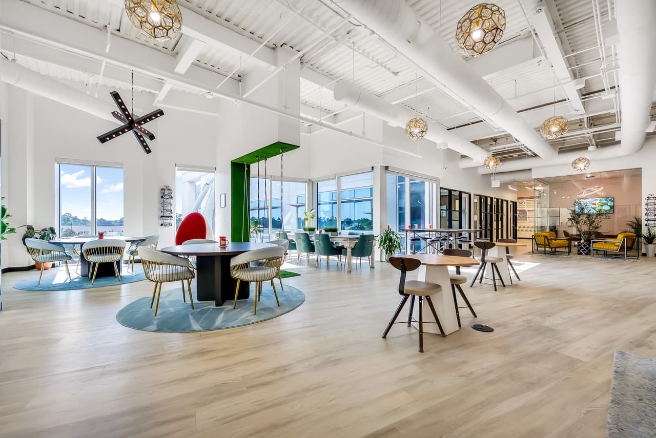 Bright open workspace with round tables and big windows at WorkLodge